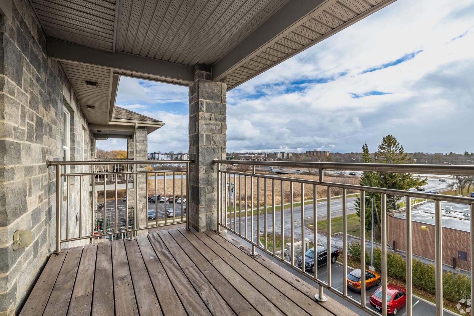Covered upper-floor balcony with a view over the creek to the west end