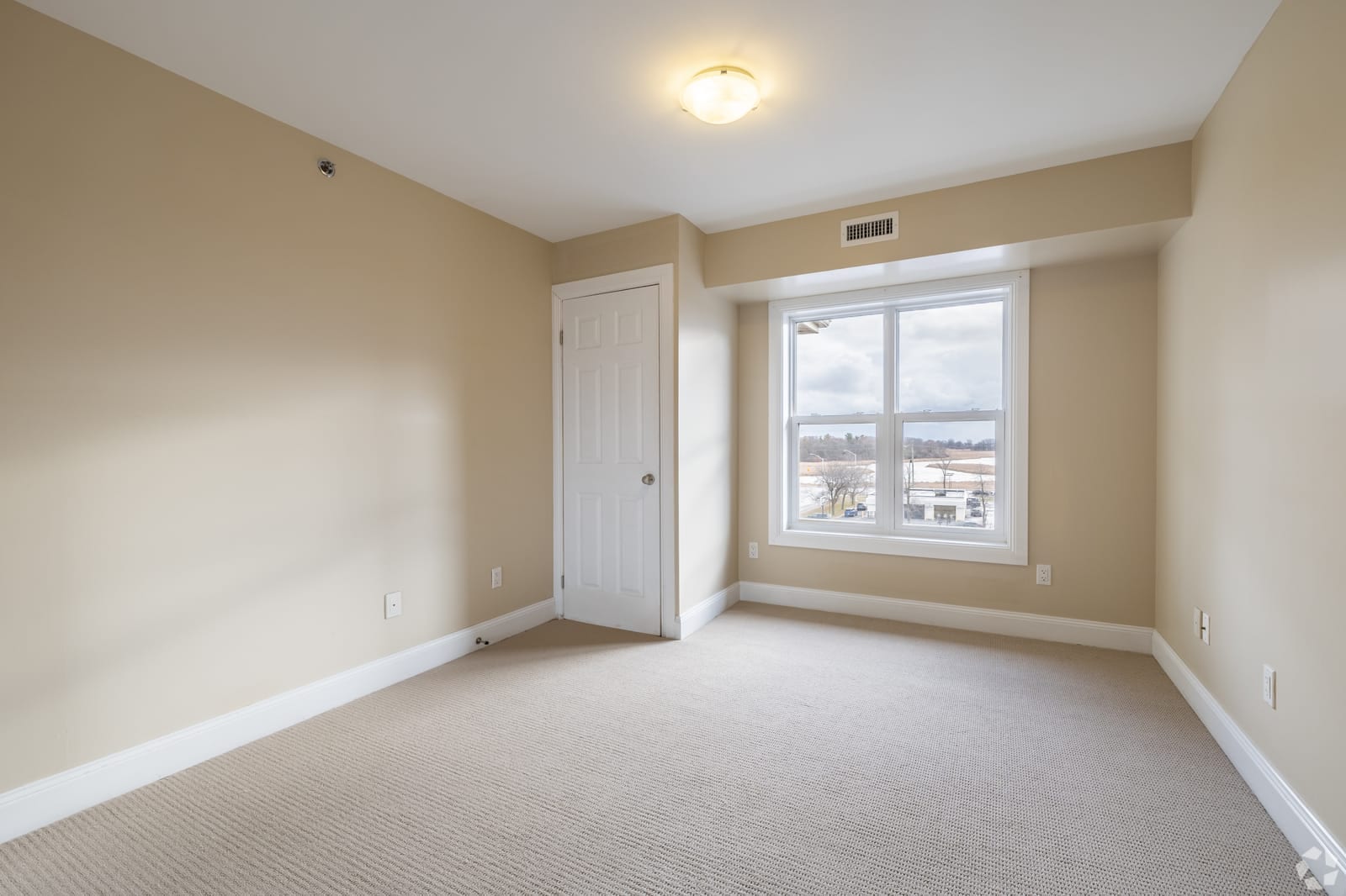 Carpeted bedroom with a view over the creek