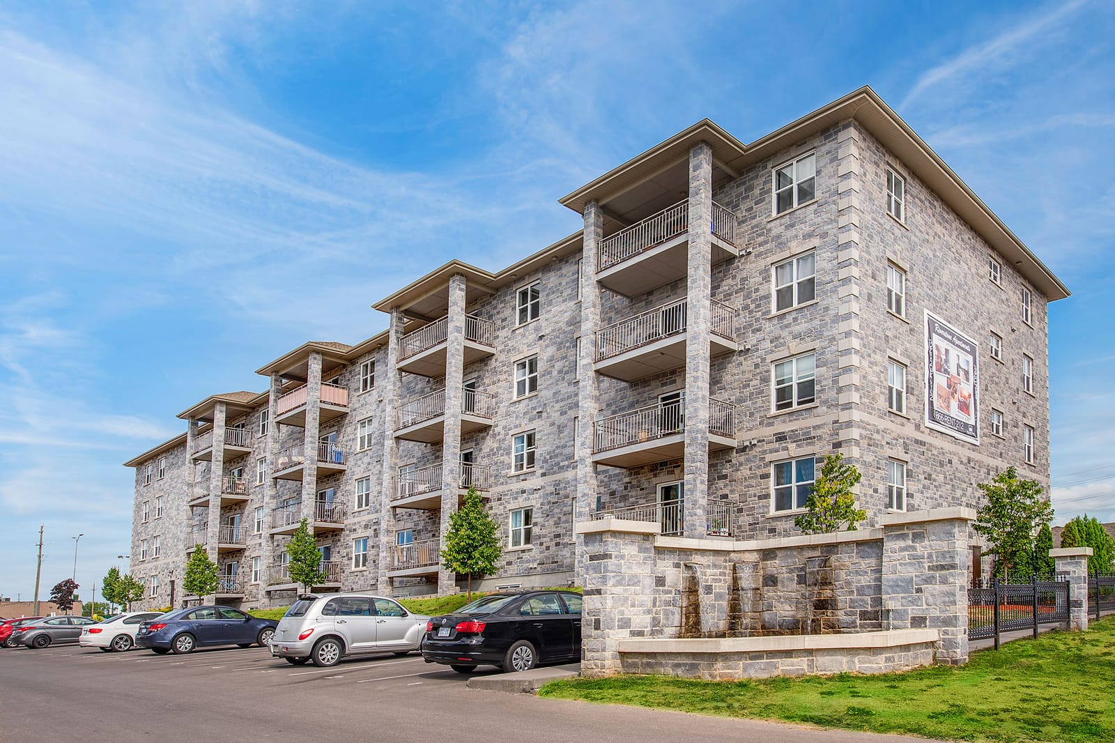 Riverstone's limestone facade from Armstrong Road, with the stone water feature at the corner