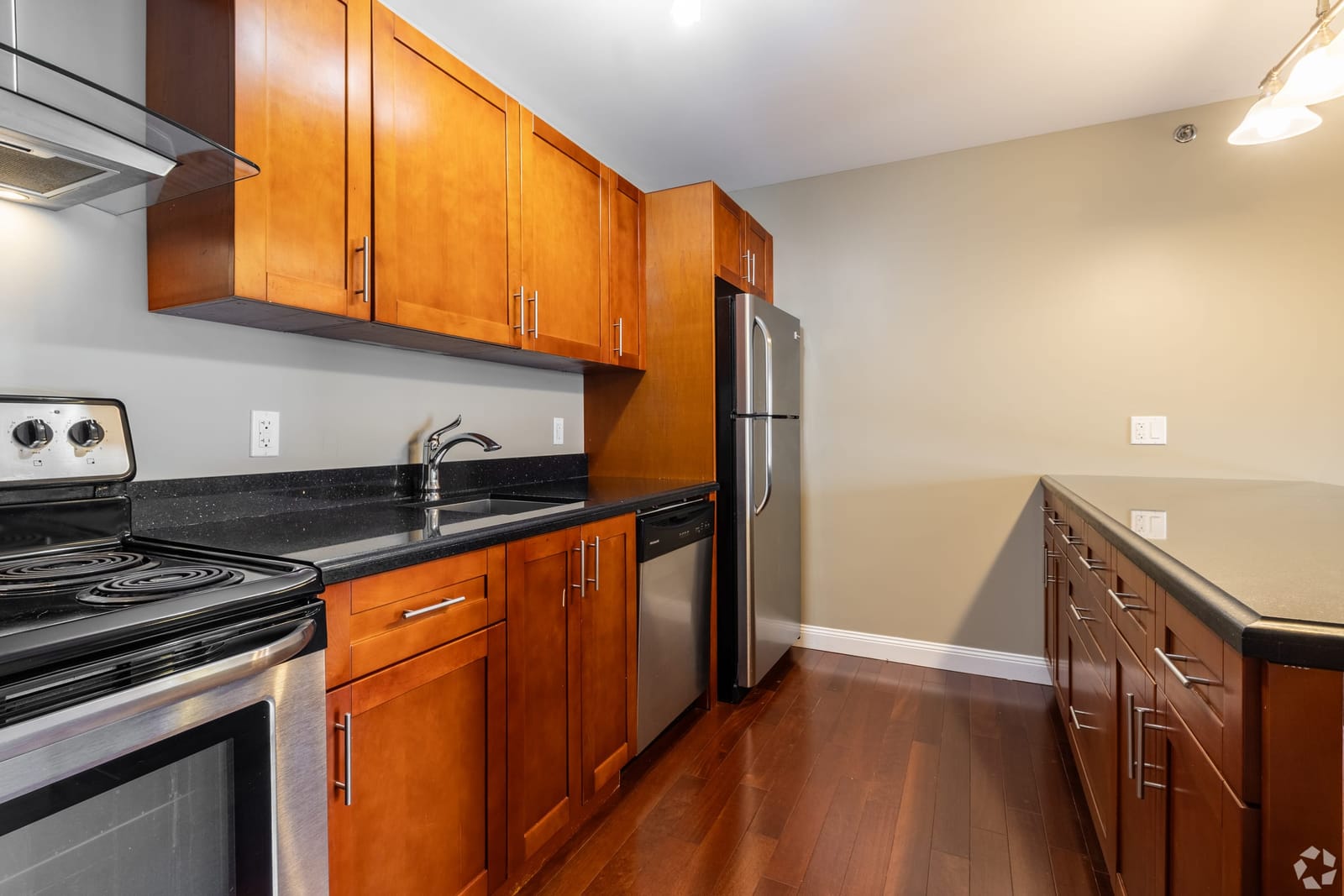 Suite kitchen with granite counters, stainless range and dishwasher