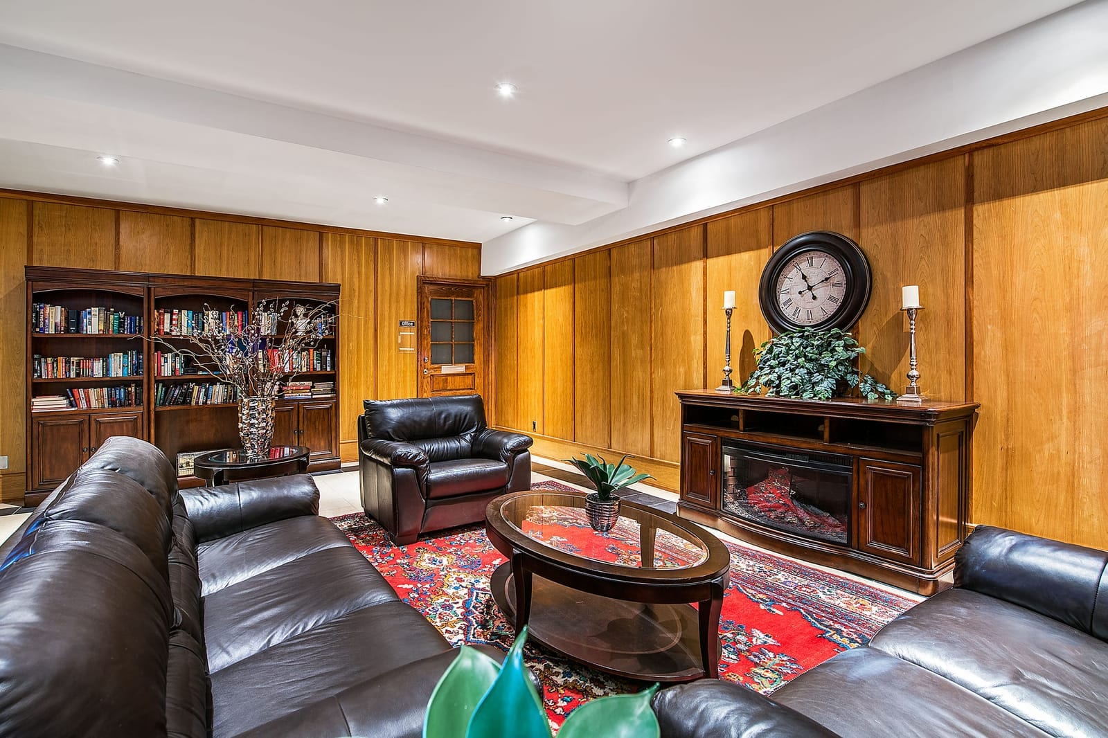 Library lounge with leather seating and a fireplace