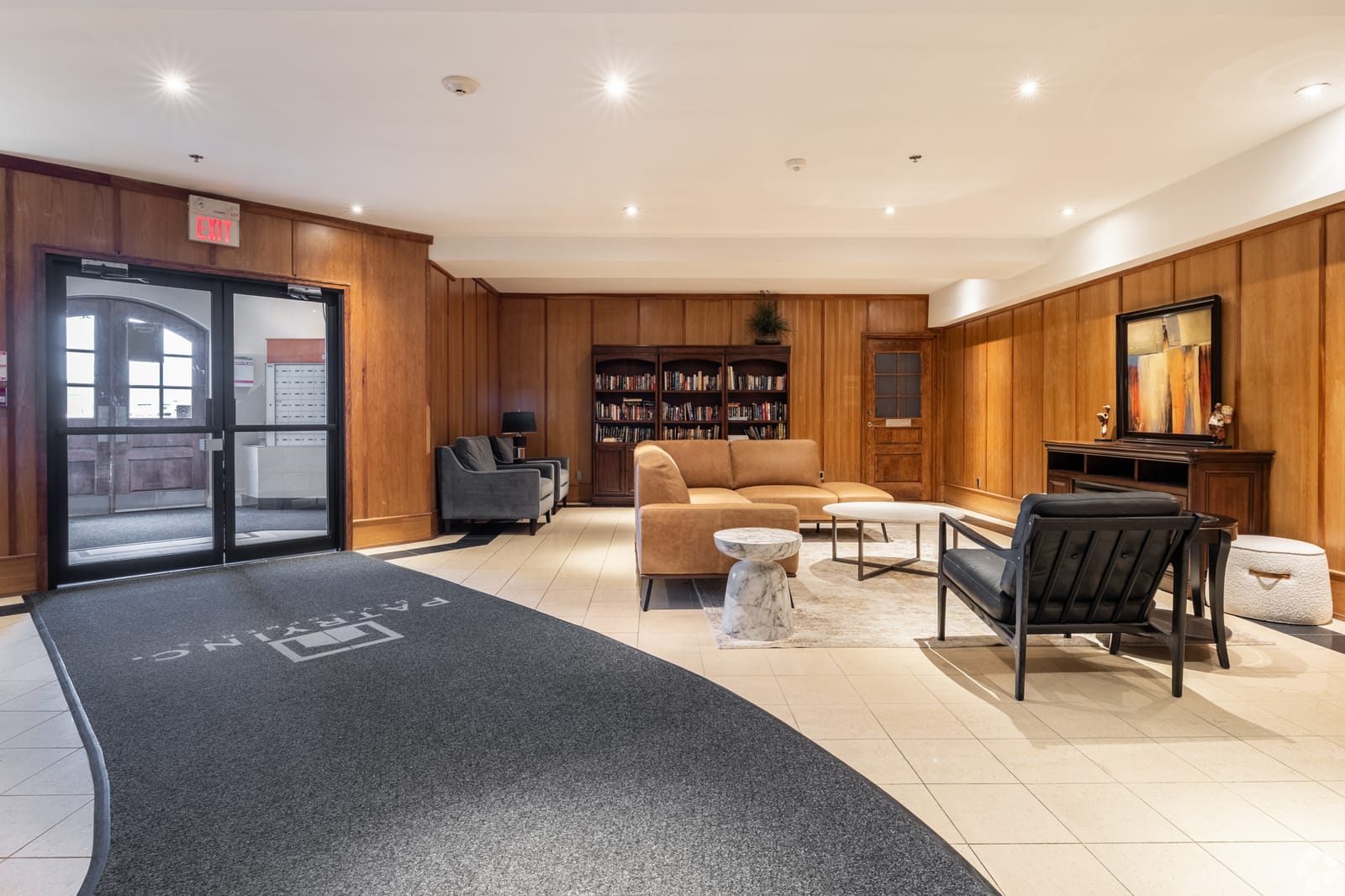 Wood-panelled lobby lounge with a library wall