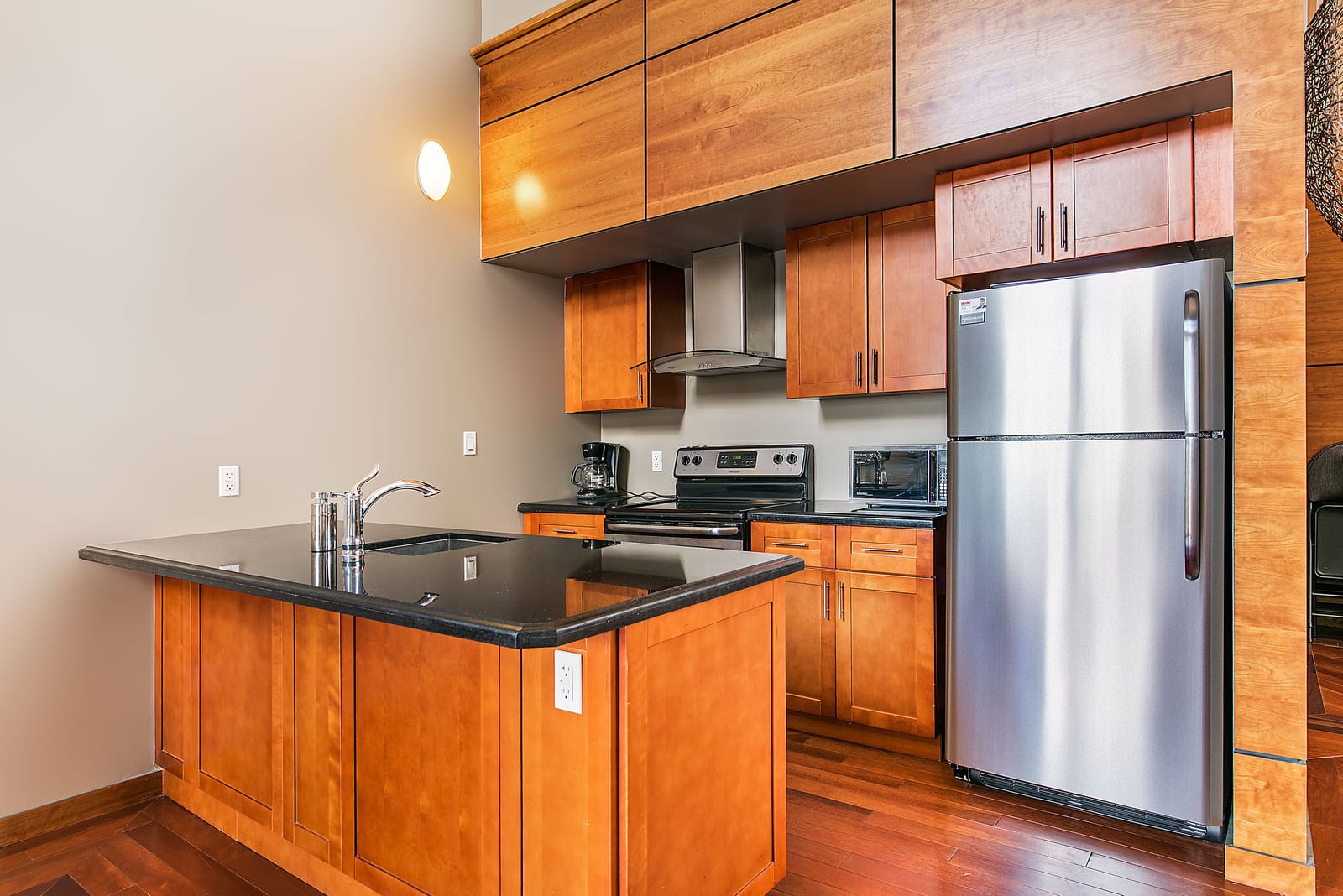 Party room kitchen with a granite island and stainless steel appliances