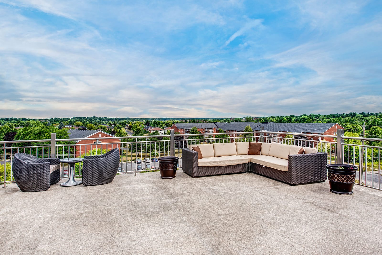 Rooftop terrace lounge with a sectional sofa and a view over the west end