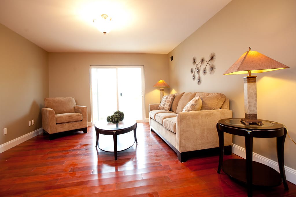 Furnished living room with hardwood floors and a walkout to the balcony