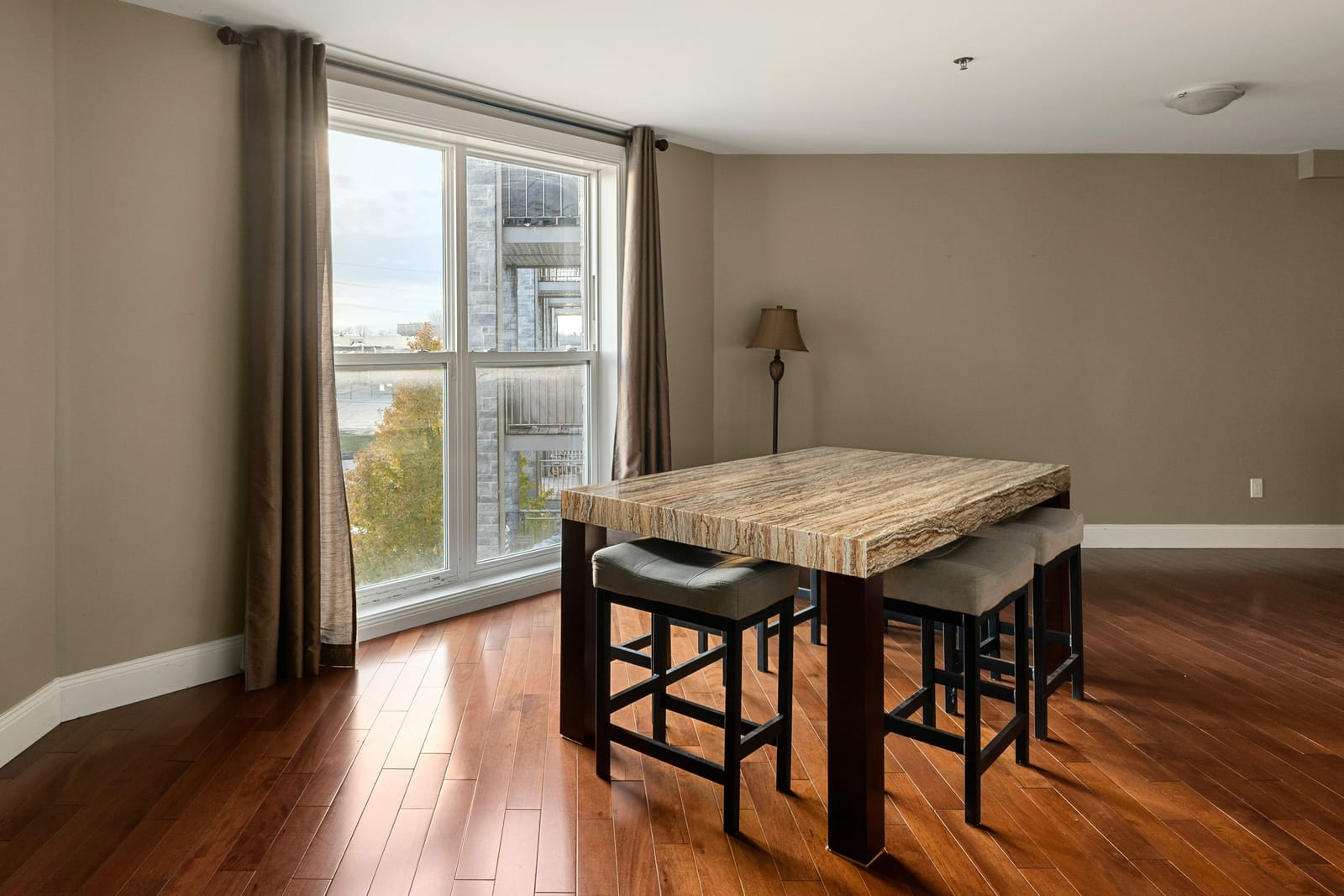 Dining area beside a full-height window